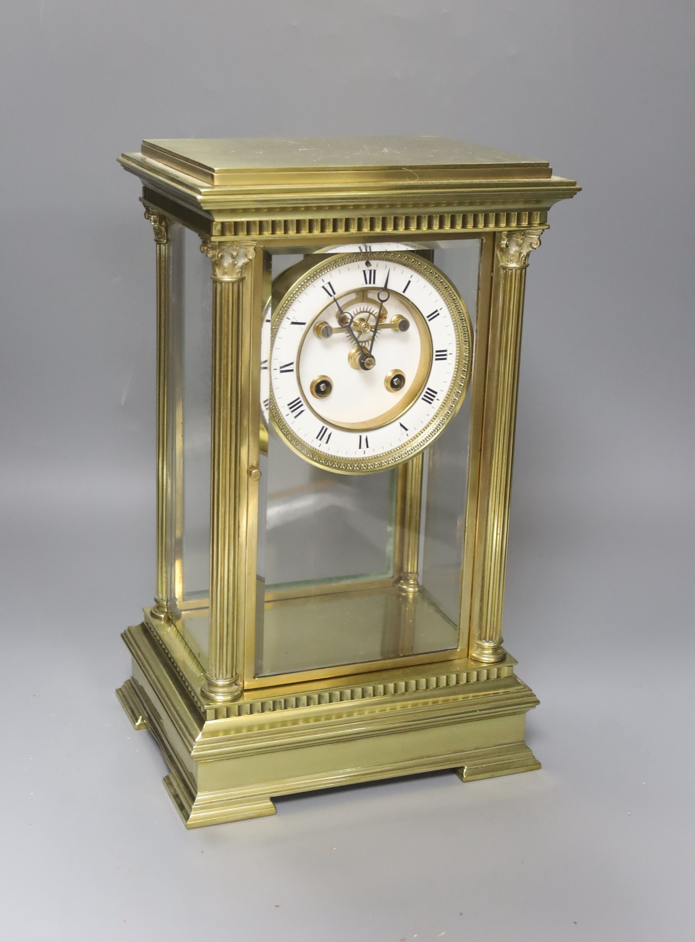 A 19th century French four-glass mantel clock with key and mercury filled pendulum bob 34cm